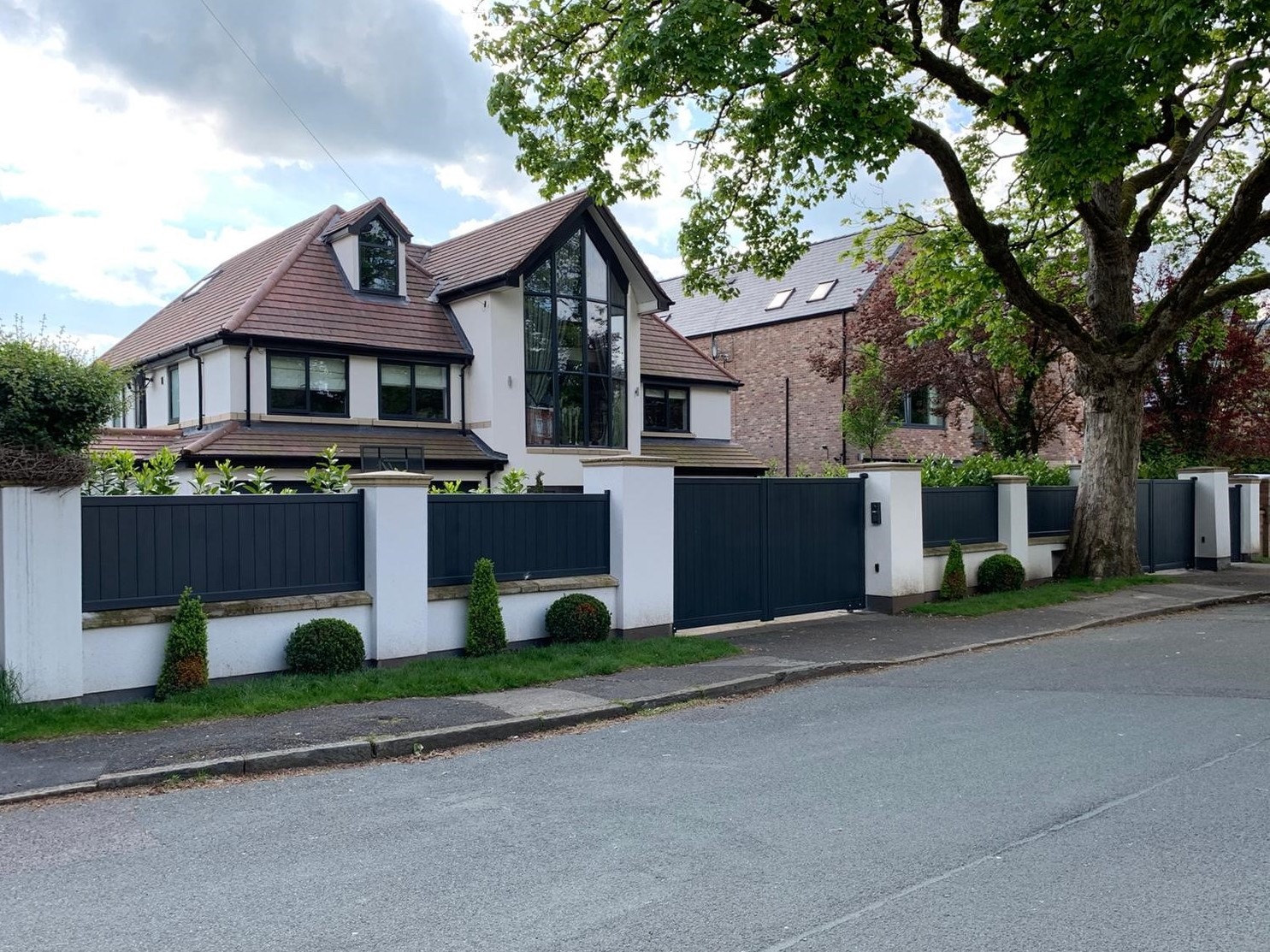 Dark Grey Aluminium Swing Gates Outside of a Modernistic House